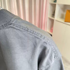 Gray T-shirt sleeve and shoulder seam with visible topstitching