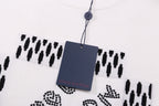 Louis Vuitton white T-shirt with black patterned design and hanging tag