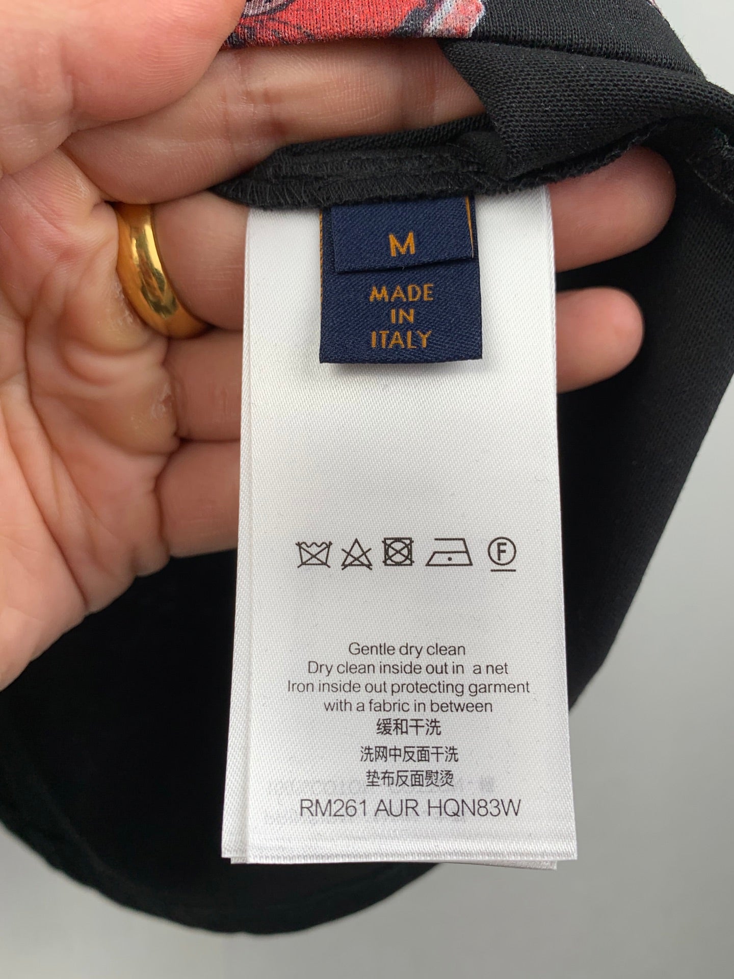 Black shorts care label with size M and Made in Italy