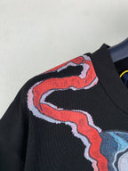Louis Vuitton black graphic T-shirt neckline area with red outline and blue accents