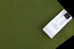 Green T-shirt close-up with stitched fabric and attached white care label