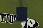 Green T-shirt with dog graphic, VUITTON lettering, and a navy hang tag