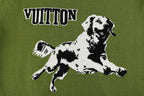 Green T-shirt close-up with black-and-white dog graphic and VUITTON text