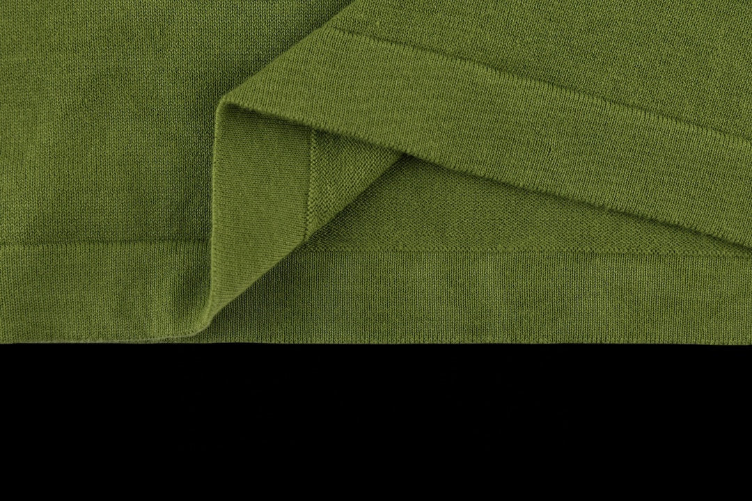 Green T-shirt folded hem with visible side seam stitching