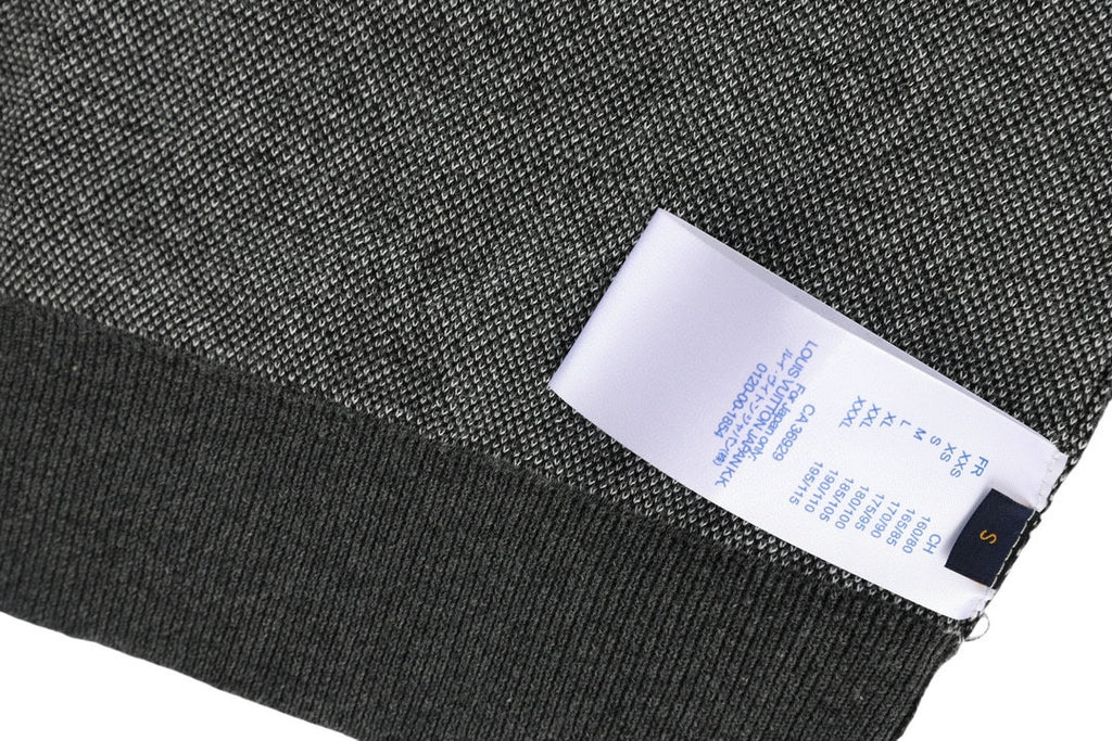 Louis Vuitton polo shirt interior label on dark knit fabric