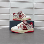 Amiri low-top sneakers in white with red details, check strap, and “AMIRI” label