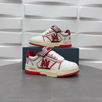 Amiri low-top sneakers with white uppers, red outsole, and check-pattern strap