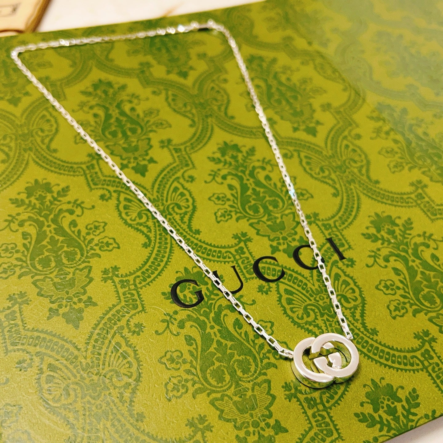 Gucci silver-tone pendant necklace with interlocking GG emblem on chain