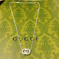 Gucci silver-tone chain necklace with GG pendant centered at chest