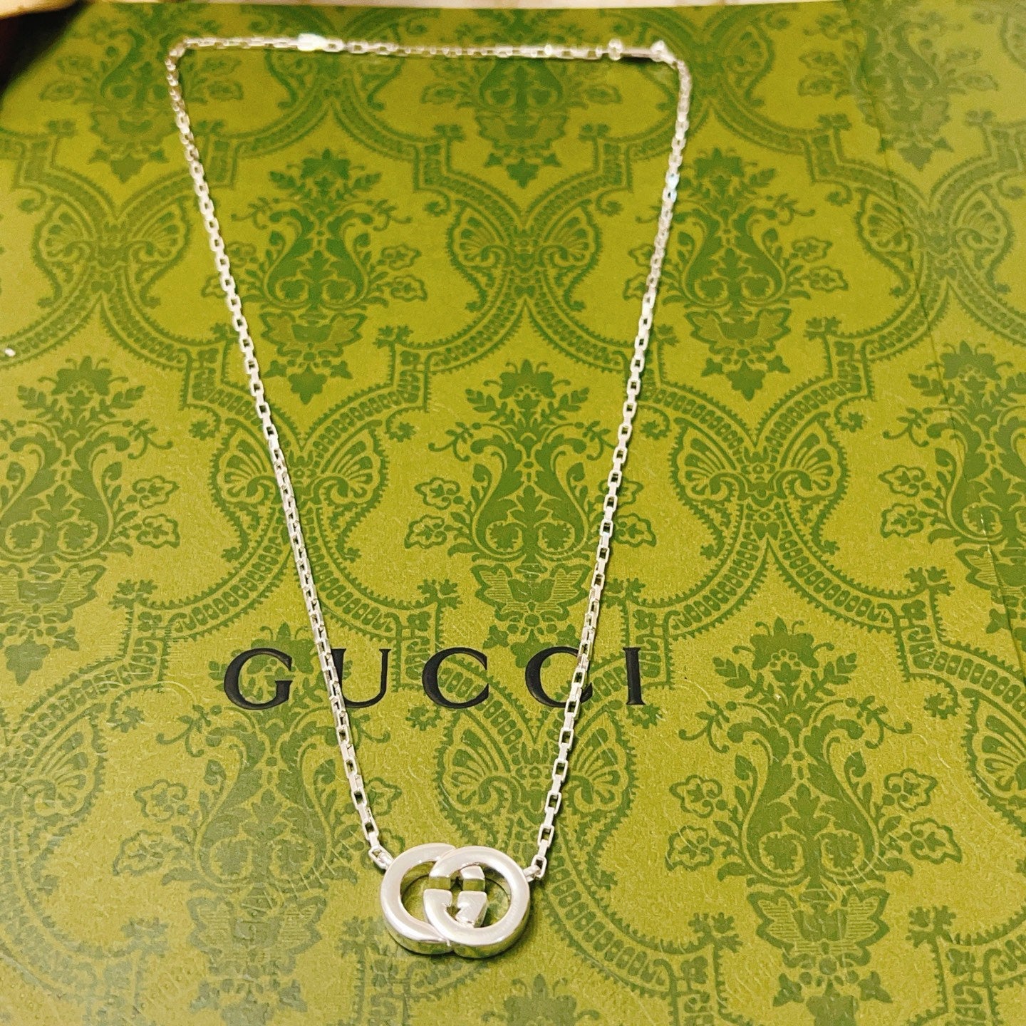 Gucci silver-tone chain necklace with GG pendant centered at chest