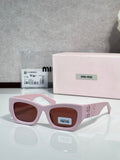 Pink oversized sunglasses with brown tinted lenses and logo on side temples
