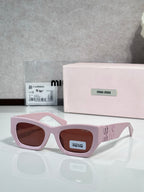 Pink oversized sunglasses with brown tinted lenses and logo on side temples