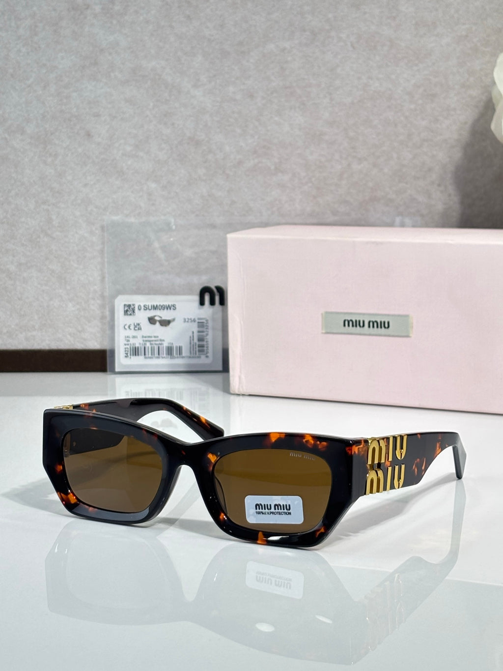 Tortoiseshell oversized sunglasses with warm brown tinted lenses and gold logo