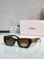 Tortoiseshell oversized sunglasses with warm brown tinted lenses and gold logo