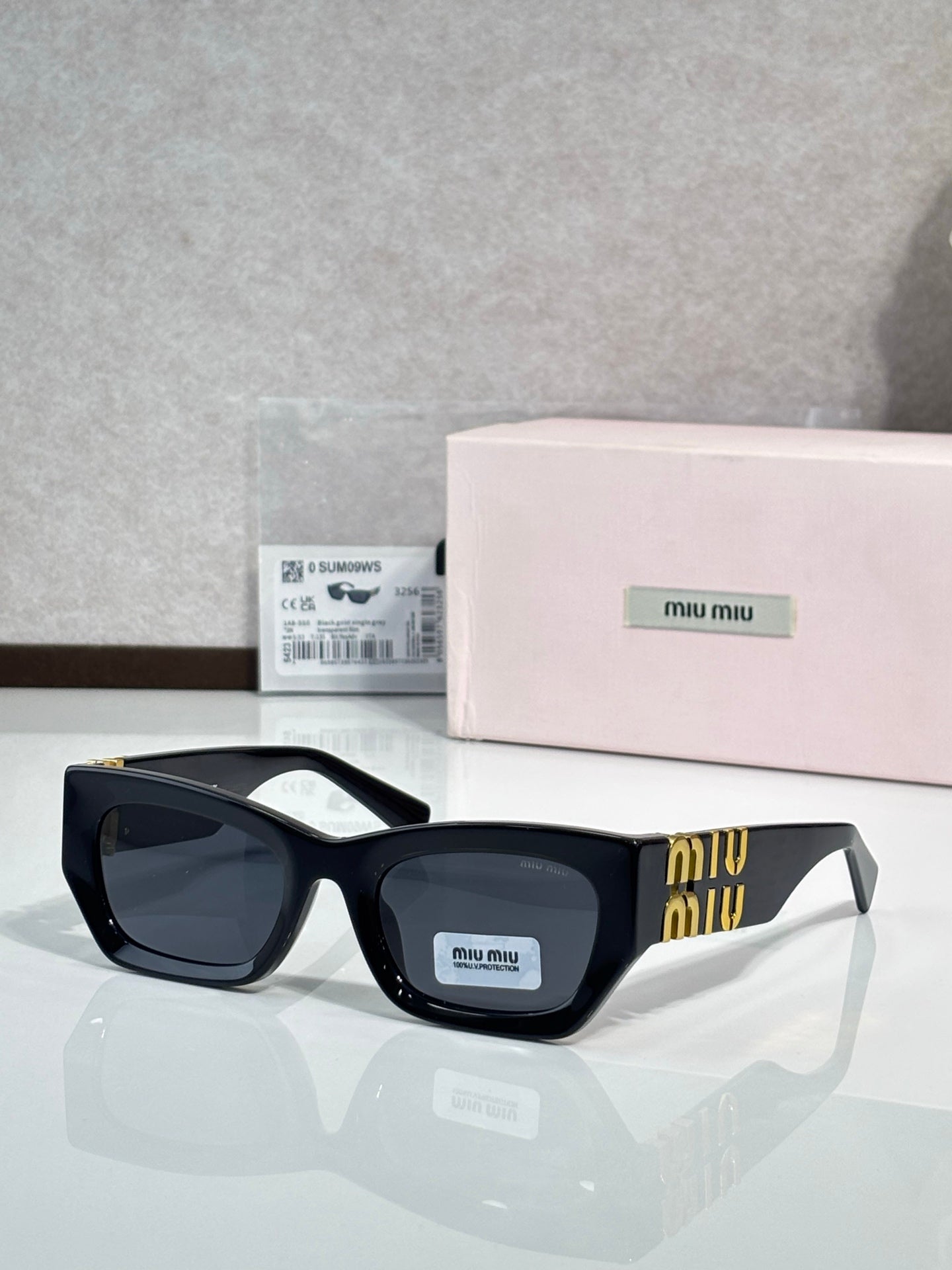 Black oversized sunglasses with dark tinted lenses and gold accent on side temples