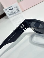 Black sunglasses with dark tinted lens and hinged side arm close-up