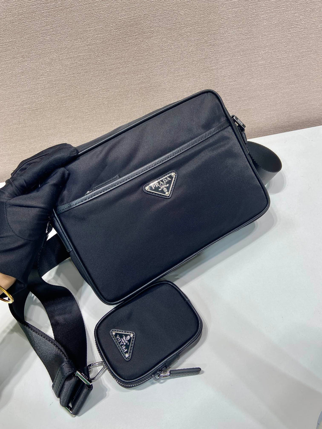 Prada crossbody bag with front logo and wide strap, dark blue; mini pouch included