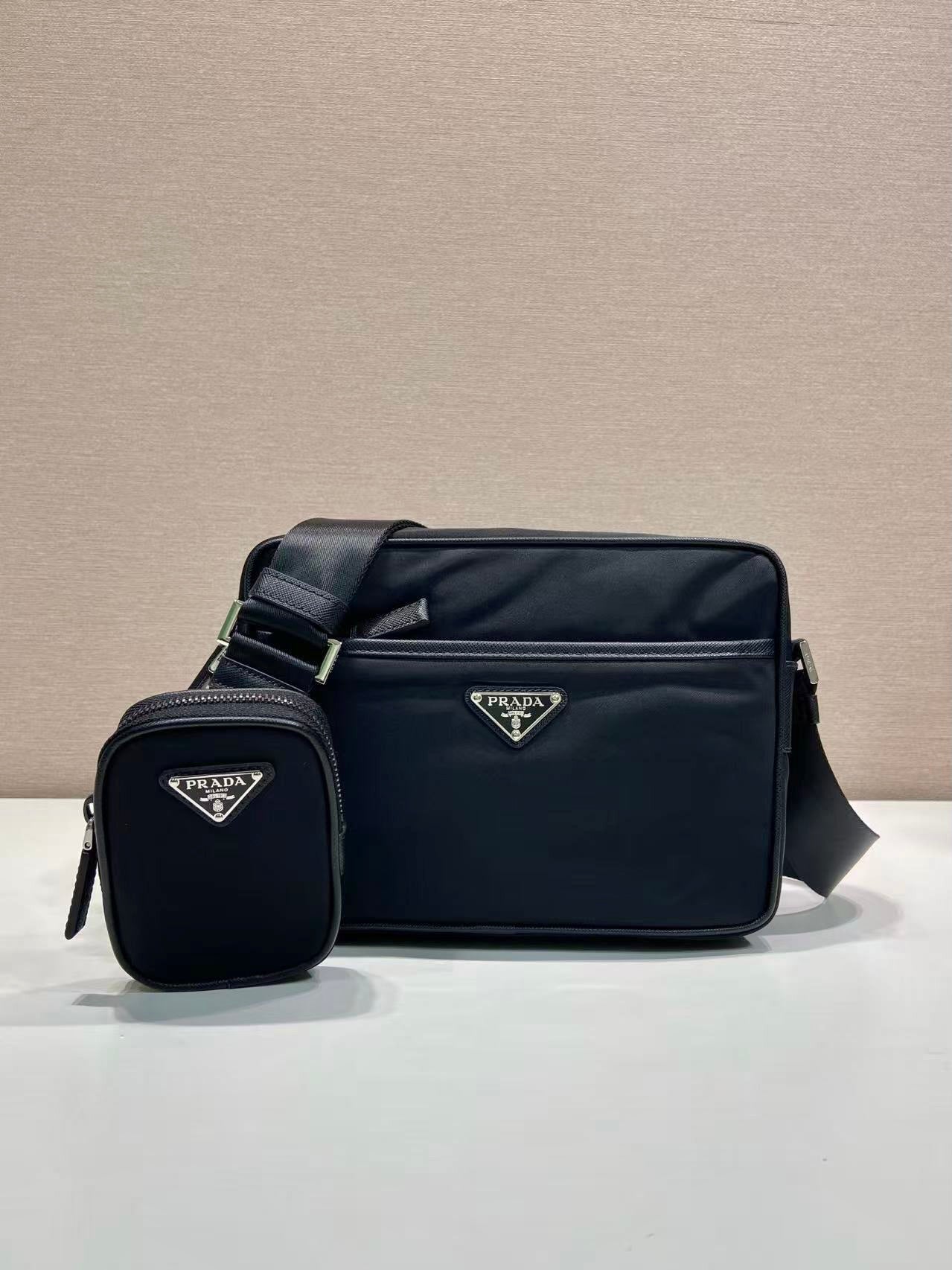 Prada nylon crossbody bag with logo plaque and matching mini pouch, dark blue