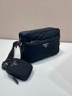 Prada crossbody bag with flap top, logo plaque, and mini pouch attached, dark blue