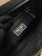 Prada interior label on dark patterned bag lining with zipper, dark blue