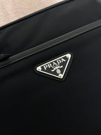 Prada logo patch on front of crossbody bag, dark blue