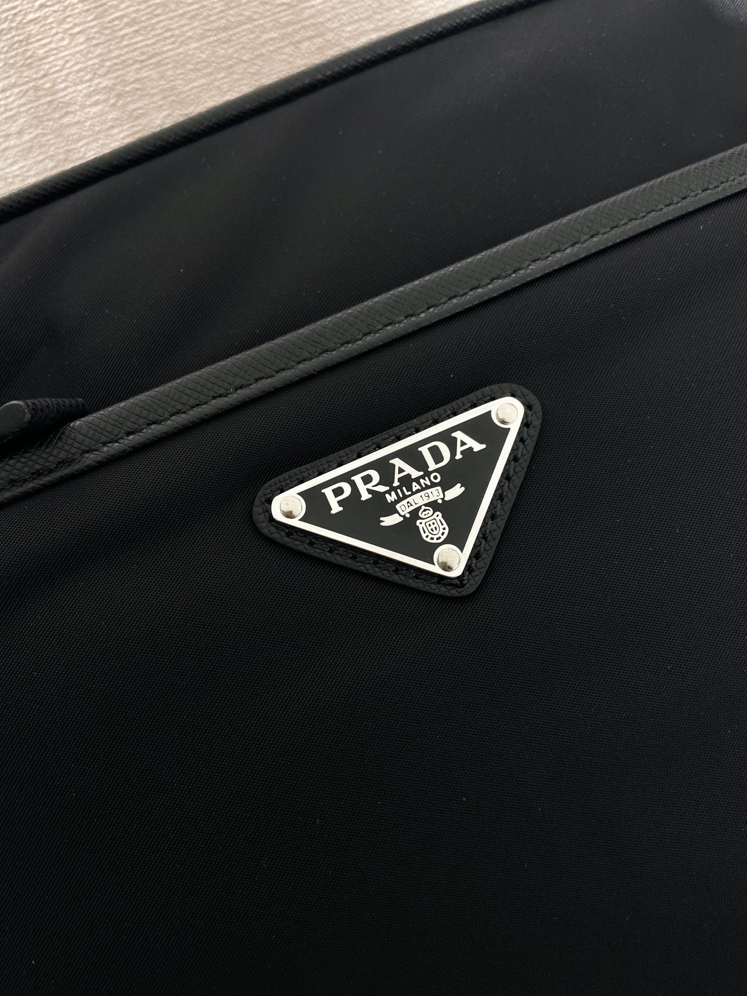 Prada logo patch on front of crossbody bag, dark blue