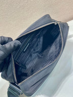 Prada bag open top view showing inner fabric and zipper lining, dark blue