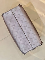 Quilted leather flap wallet on chain with Chanel CC emblem, silver tone, angled view