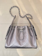 Quilted leather shoulder bag with chain top handles and Chanel logo charm, silver tone