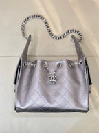 Quilted leather shoulder bag with chain handles, front Chanel CC charm, and side tabs, silver