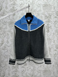 Zip-front knit vest with blue yoke and white trim, dark gray body, striped hem cuffs