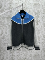 Colorblock knit zip sweater with blue collar, black body, and white braided trim