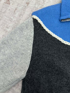 Knit sweater side panel close-up with white braided trim along the zipper edge