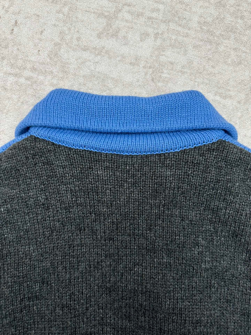 Blue knit collar on dark gray zip sweater