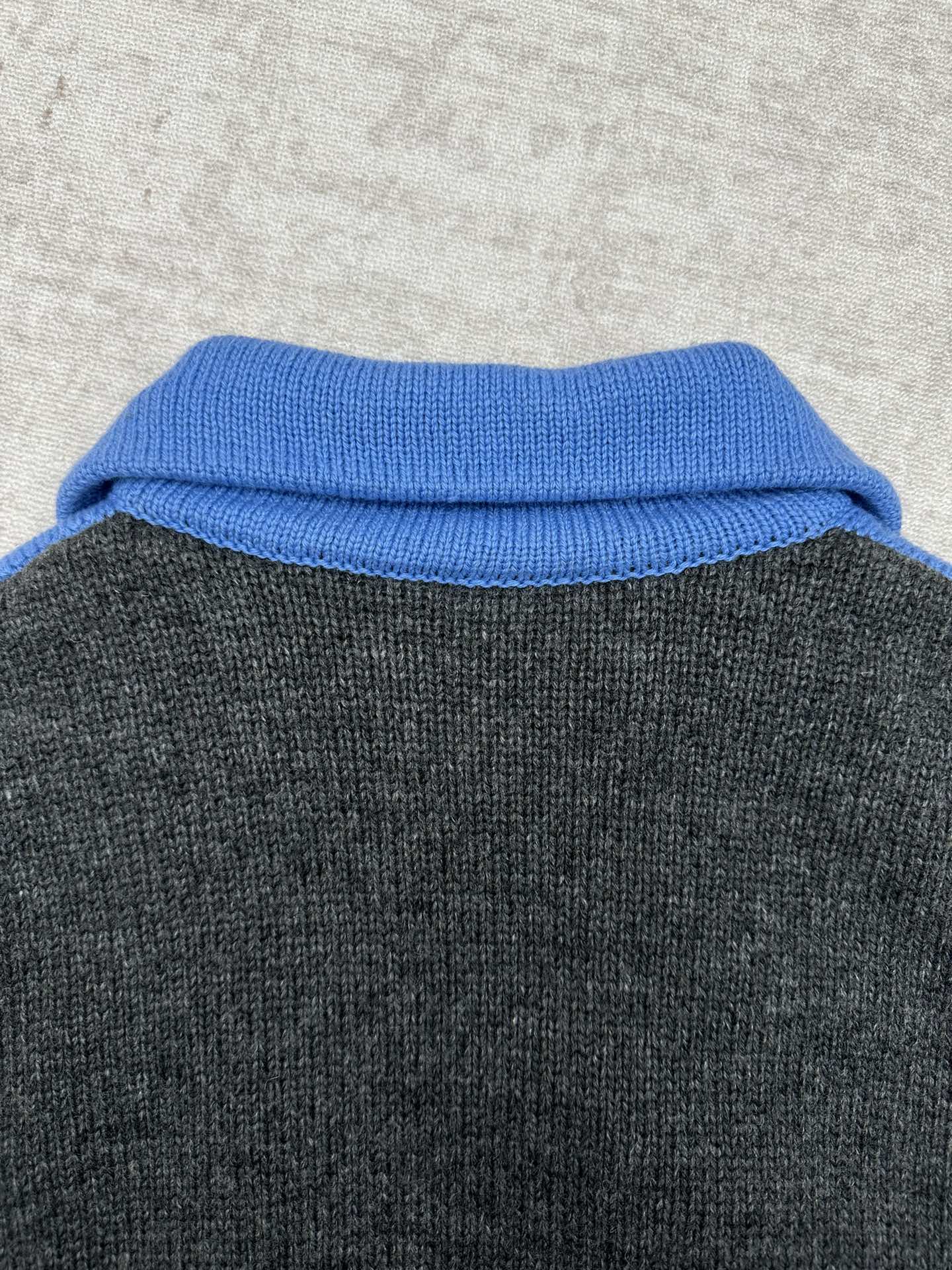 Blue knit collar on dark gray zip sweater