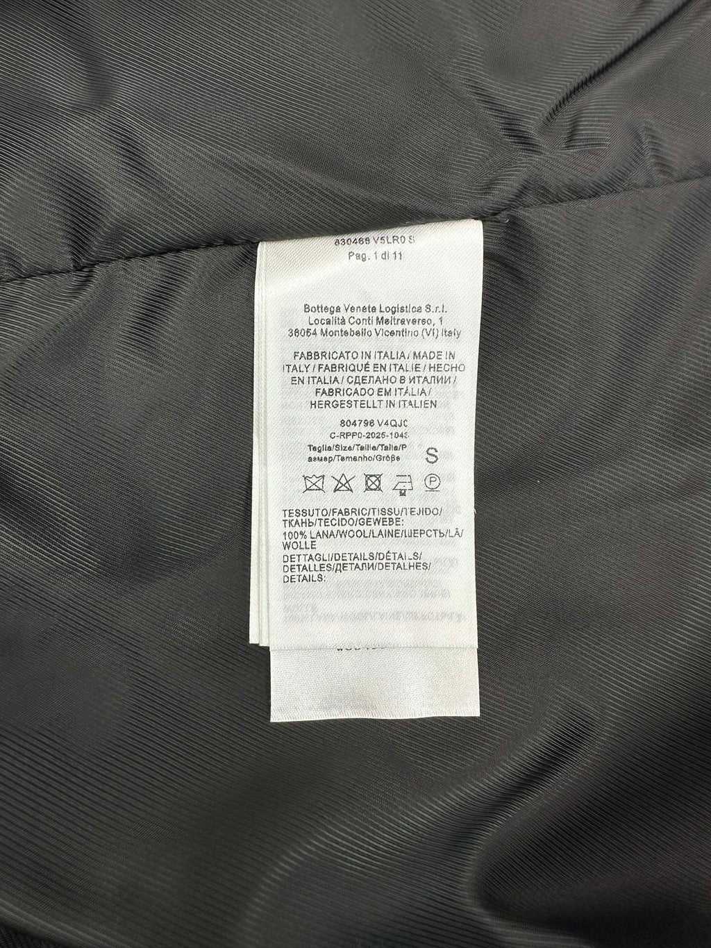 Size and fabric care label inside knit vest, sewn to dark lining