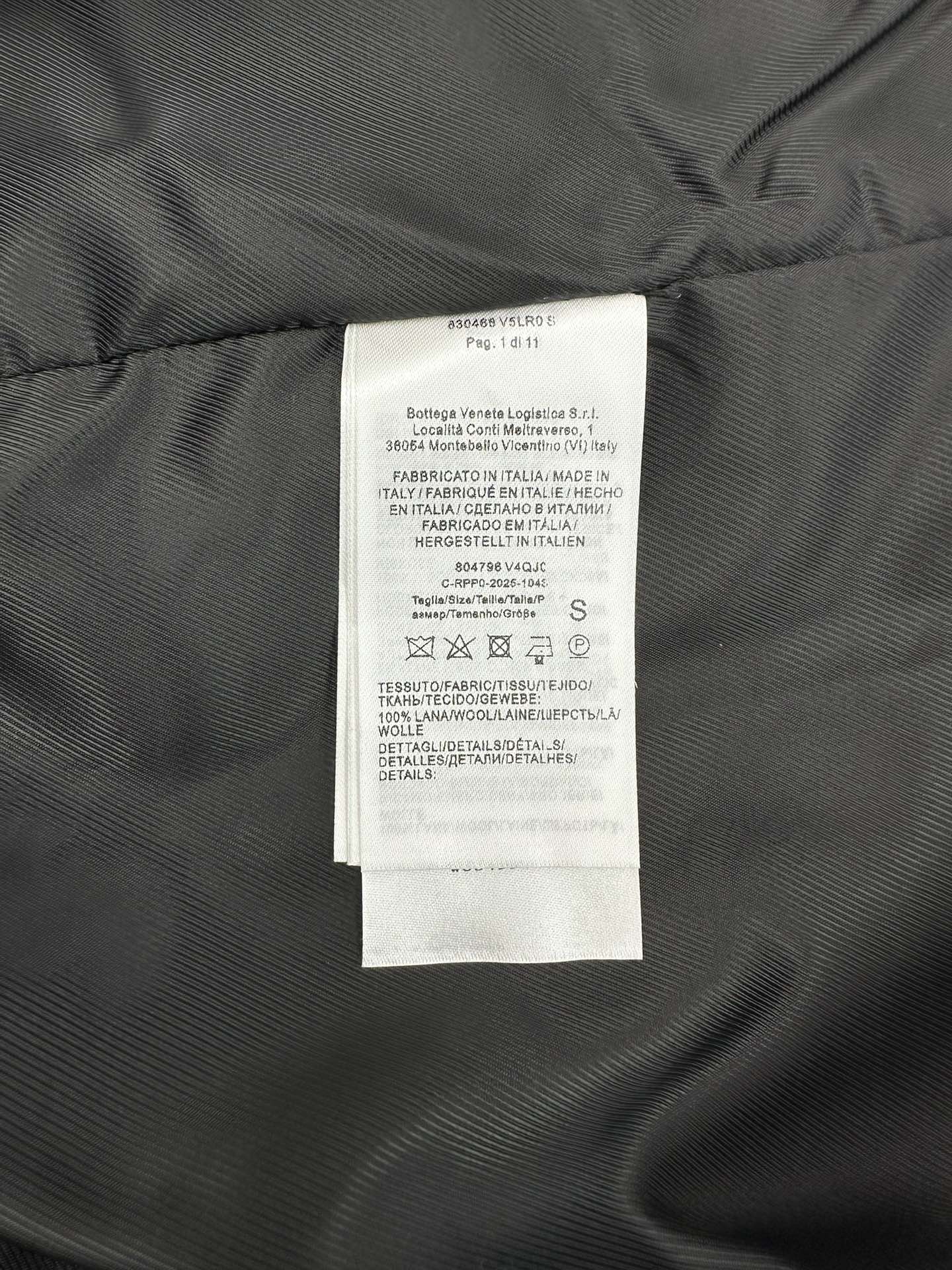 Size and fabric care label inside knit vest, sewn to dark lining