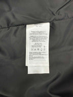 Inside care label on knit sweater with printed text on a white tag