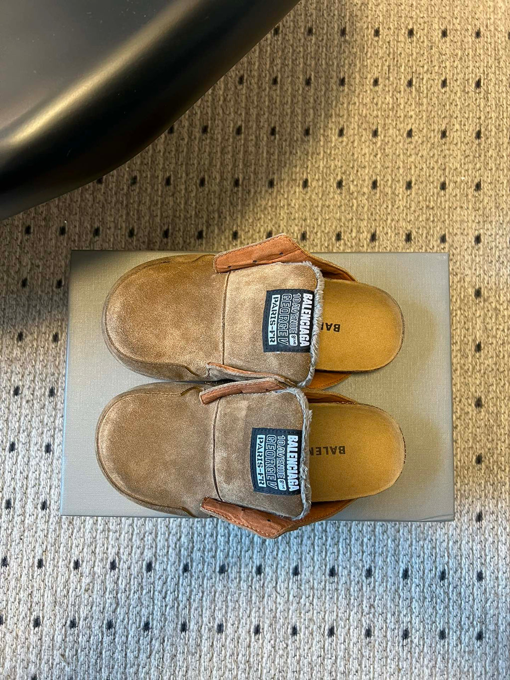 Tan suede Balenciaga slide sandals with logo patches, top view