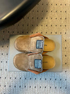 Tan suede Balenciaga slide sandals with logo patches, top view