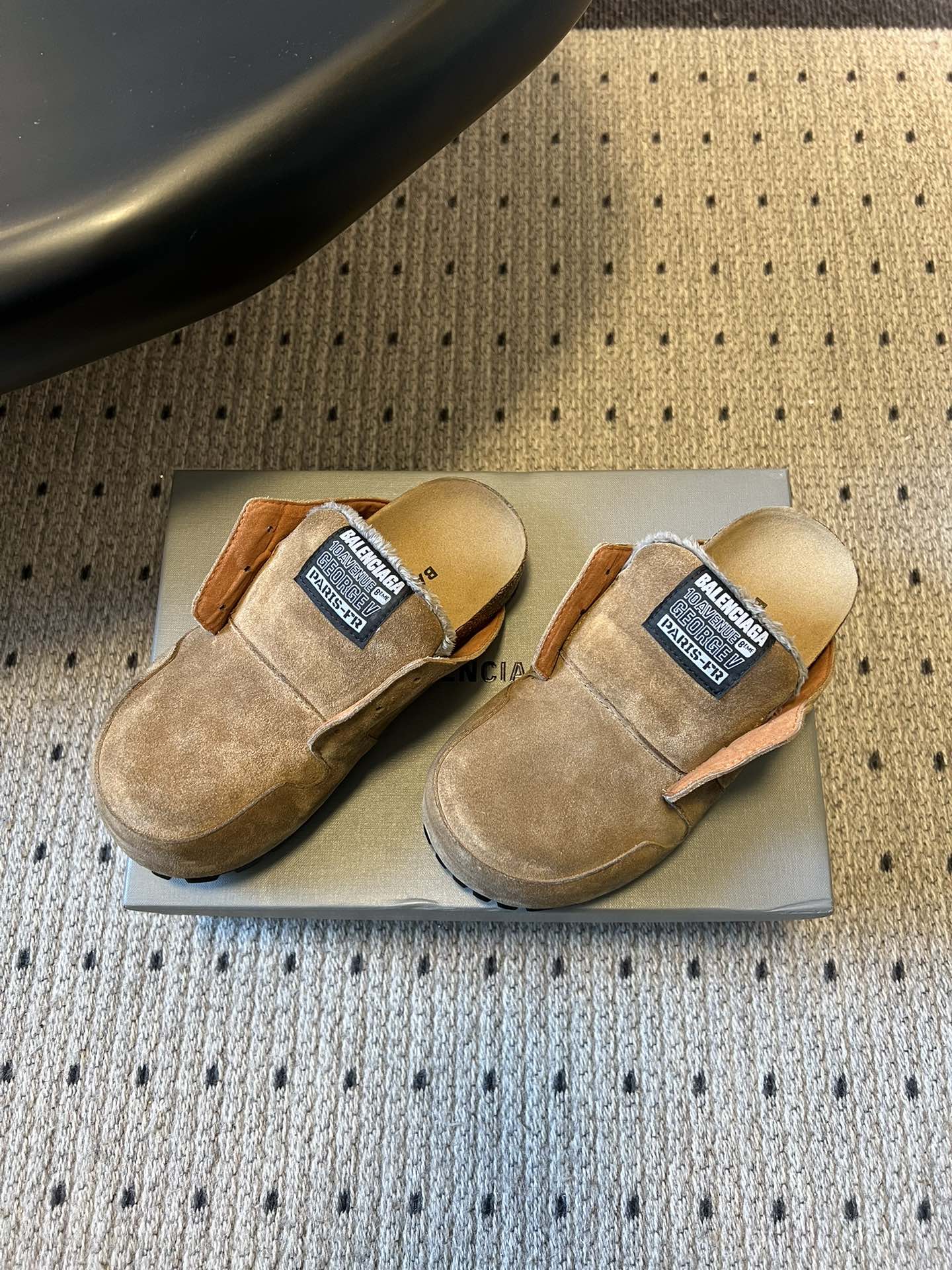Tan suede Balenciaga slip-on sandals, side view, orange trim, logo label