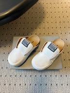 Balenciaga white slide sandals, side view, with black logo label