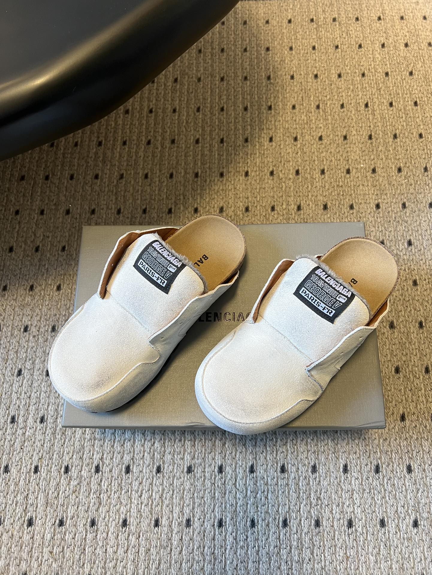 Balenciaga white slide sandals, side view, with black logo label