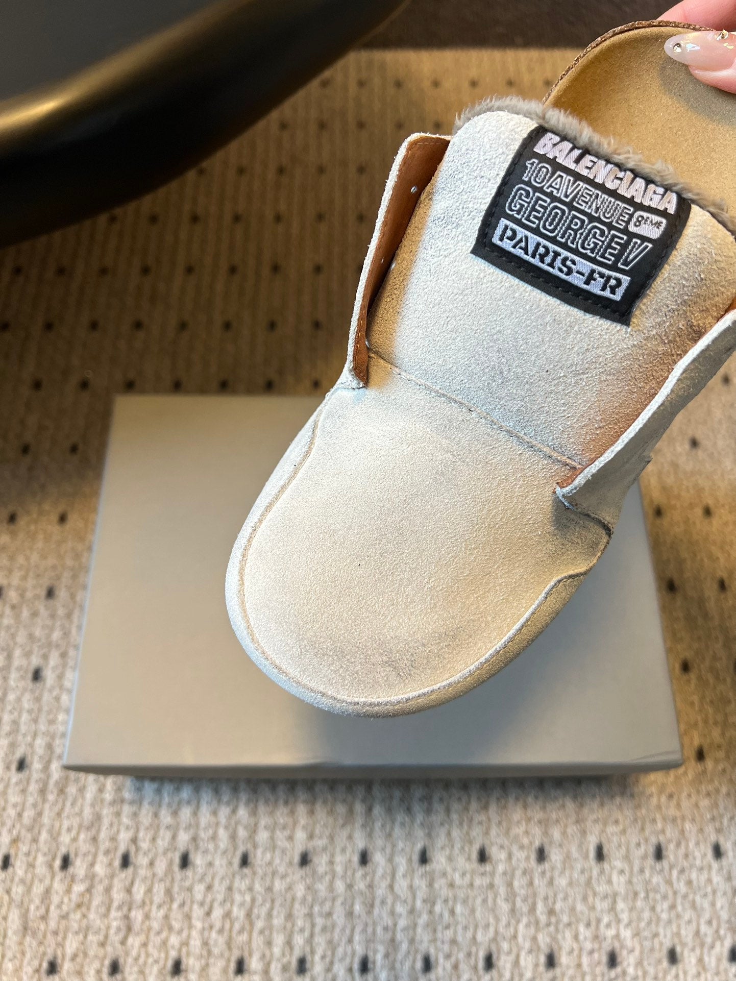 Balenciaga white slide sandal with black logo label on the vamp