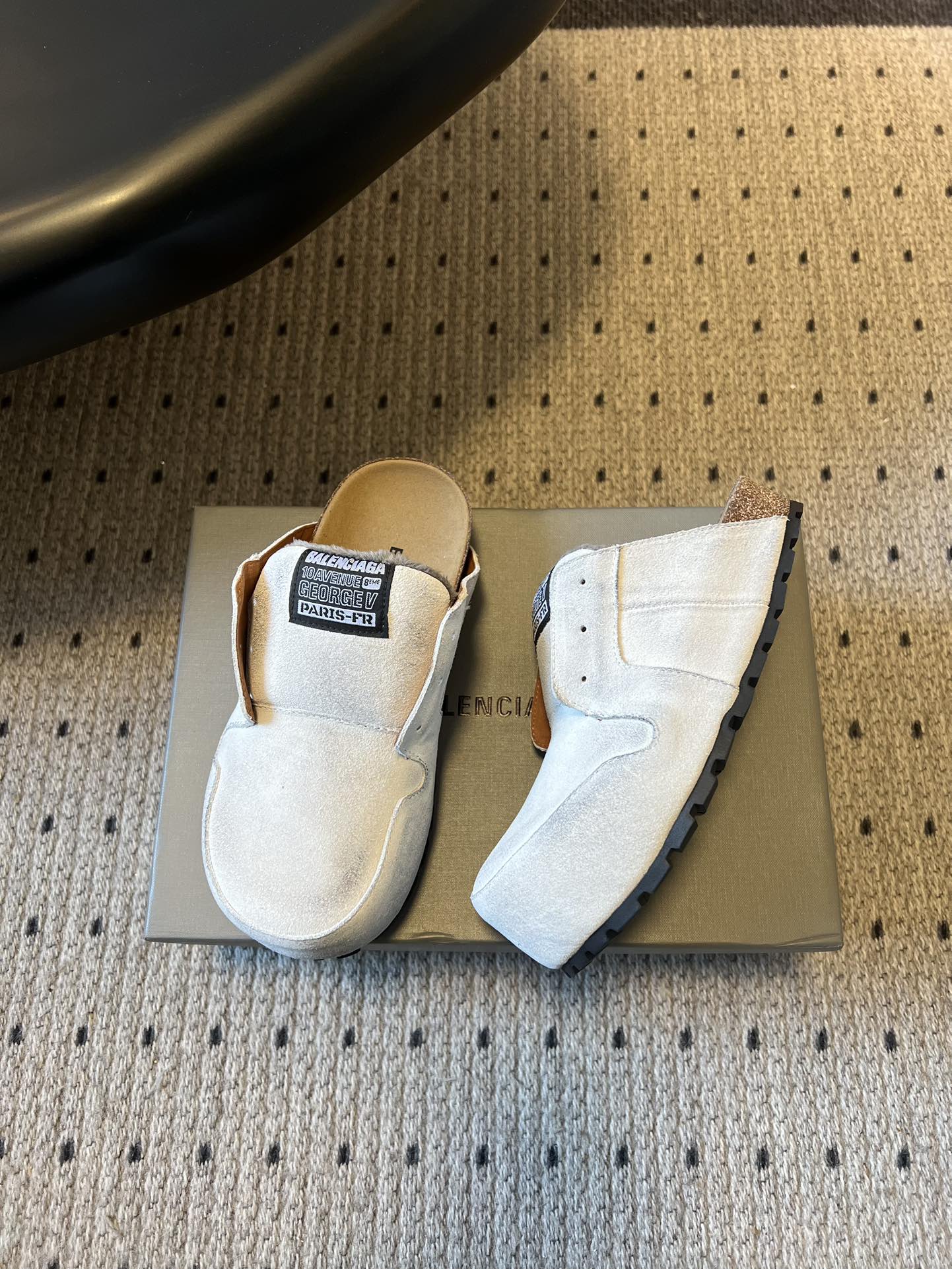 Balenciaga white slide sandals, one showing the side and toe profile
