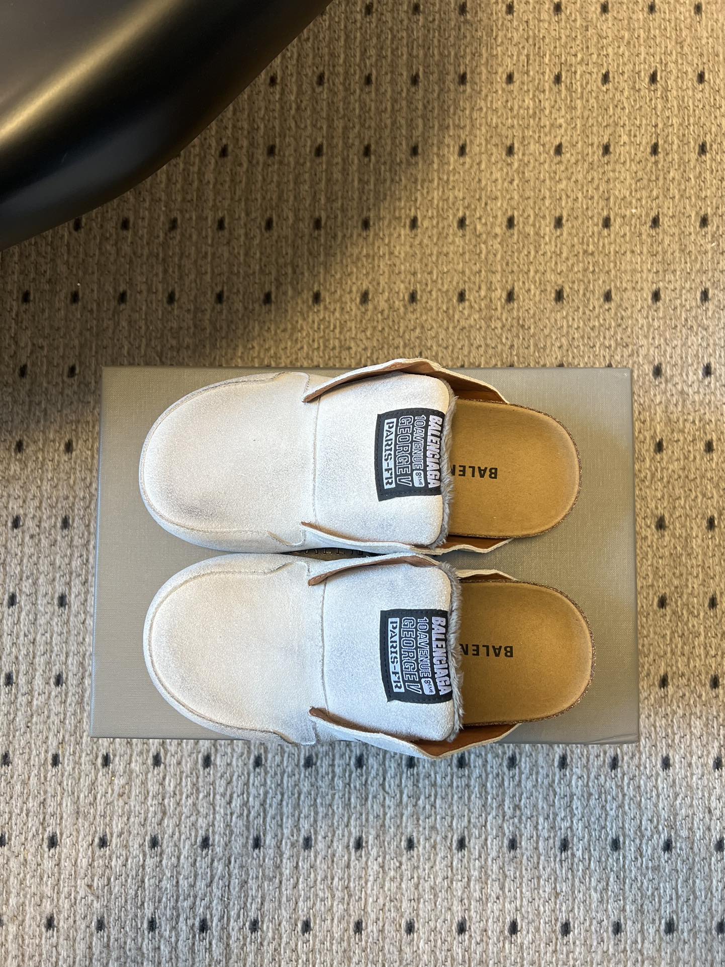 Balenciaga white slide sandals with black size label and tan footbed