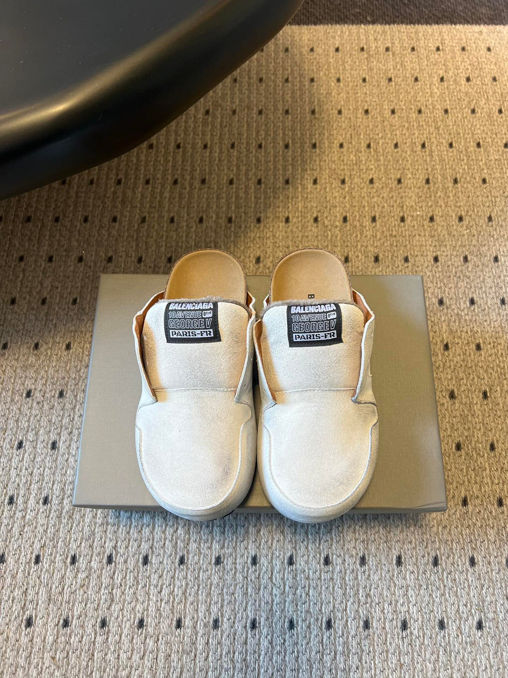 Balenciaga white slide sandals with black logo label on the strap