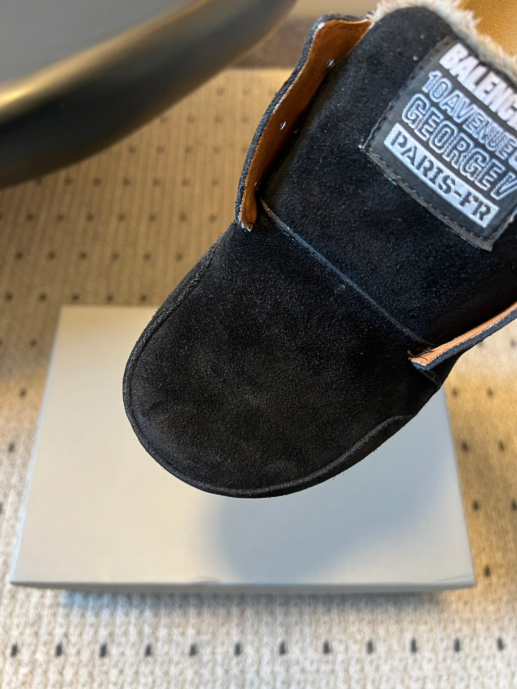 Black suede slide sandal with Balenciaga label patch on side