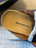 Balenciaga logo printed on tan suede insole of black slide sandal