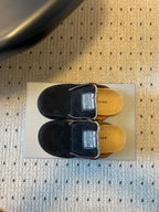 Black suede slide sandals, top view with Balenciaga logo on footbed
